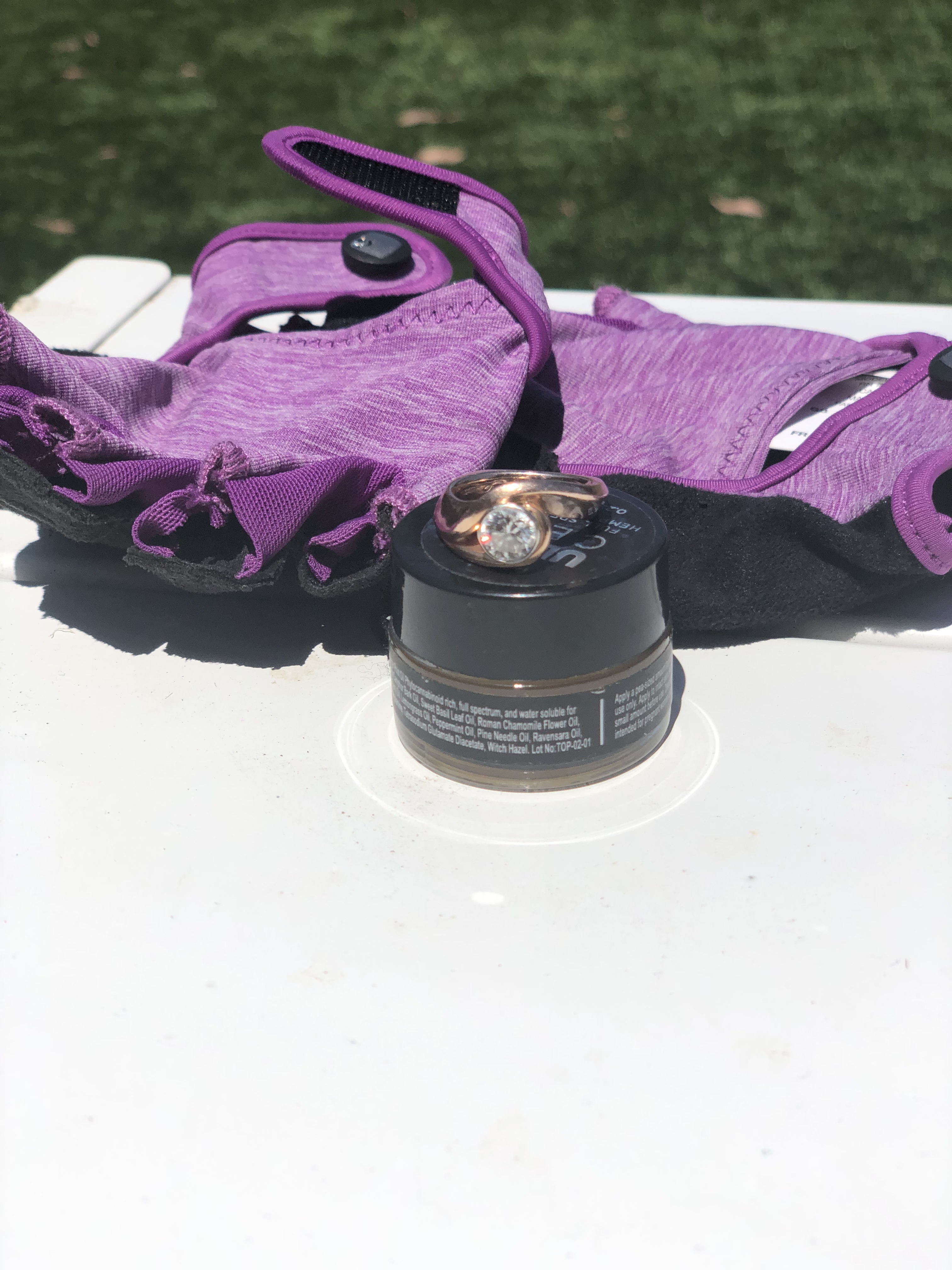 pair of gloves, a wedding ring, topical CBD ointment